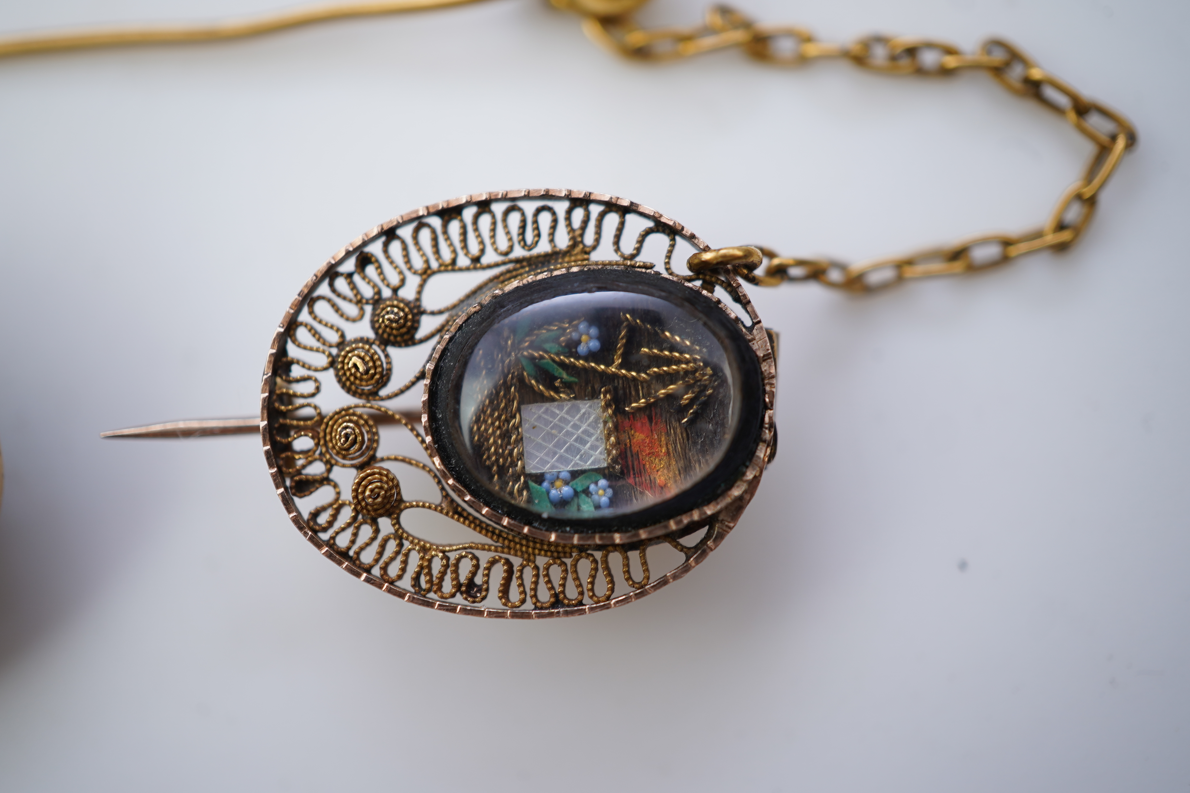 A collection of shell cameo brooches, comprising: a cameo depicting Bacchus, in a gold mount in the Archaeological Revival style, decorated with rope twist and a twisted knife wire border, length 4.4cm; together with sev